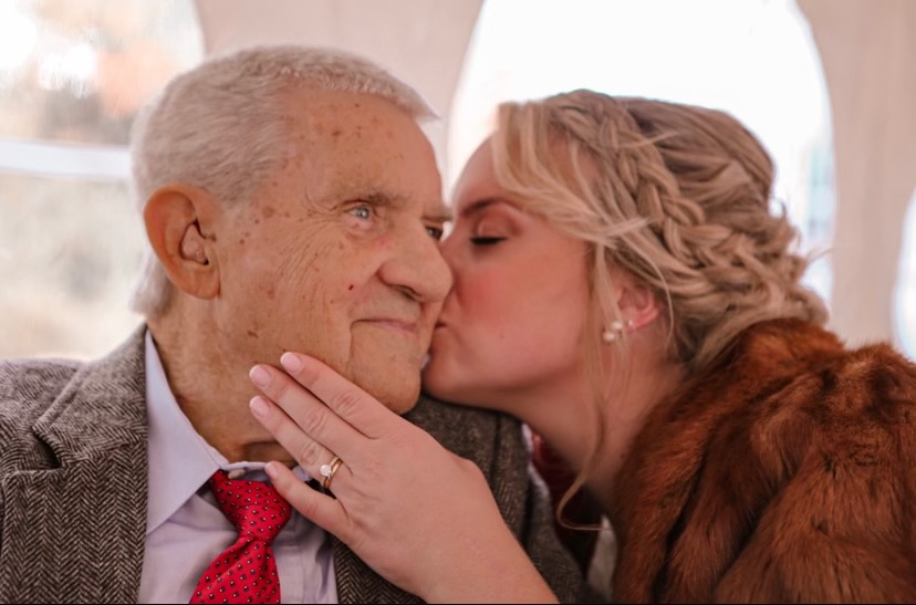 Britton kissing her grandfather Ted on the cheek